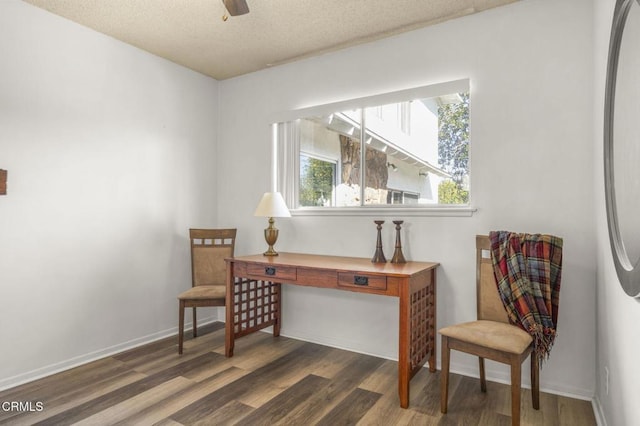 office space with baseboards, a textured ceiling, wood finished floors, and a ceiling fan