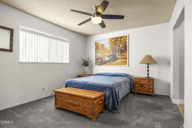 bedroom featuring baseboards, a textured ceiling, a ceiling fan, and carpet