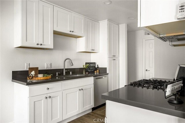 700 W La Veta Ave Unit I11, Orange, CA 92868 - kitchen with a sink, dishwasher, dark countertops, dark wood-style flooring, and white cabinetry