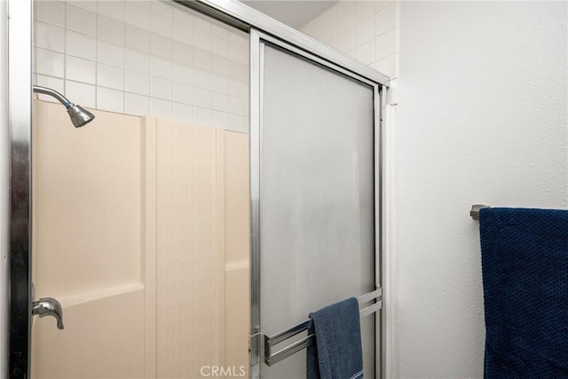 bathroom with a shower with door