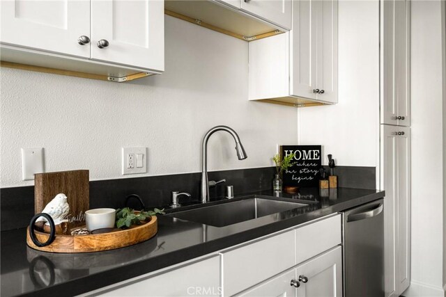700 W La Veta Ave Unit I11, Orange, CA 92868 - kitchen with stainless steel dishwasher, a sink, white cabinetry, and dark countertops