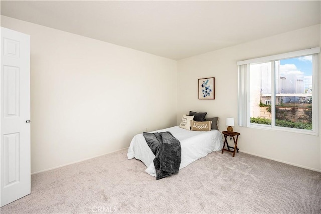 carpeted bedroom with baseboards
