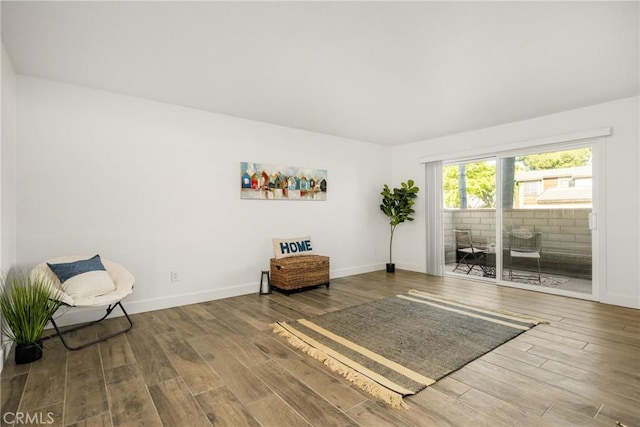 sitting room with wood finished floors and baseboards
