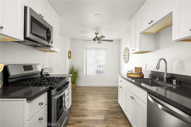 700 W La Veta Ave Unit I11, Orange, CA 92868 - kitchen with appliances with stainless steel finishes, a sink, dark countertops, a ceiling fan, and baseboards