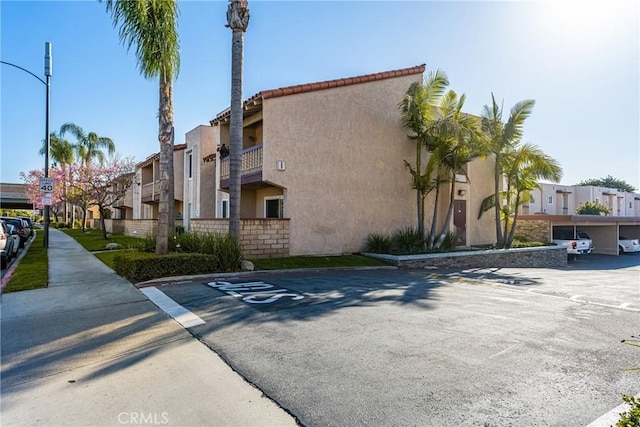 700 W La Veta Ave Unit I11, Orange, CA 92868 - view of building exterior with covered and uncovered parking and a residential view
