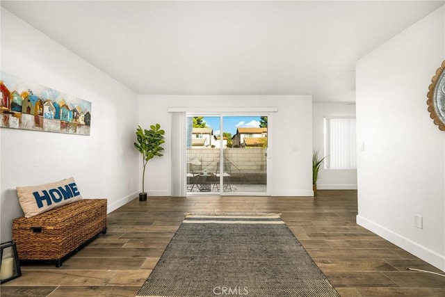 living area with wood finished floors and baseboards