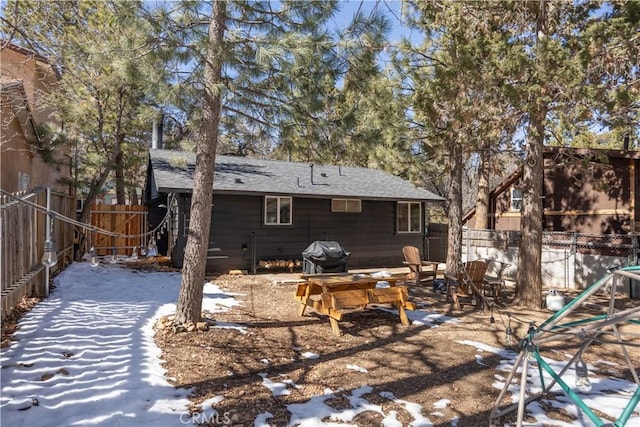 back of house with a patio area, a fenced backyard, and roof with shingles