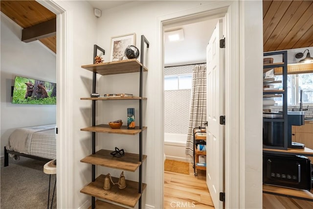 interior space with wood finished floors and beam ceiling