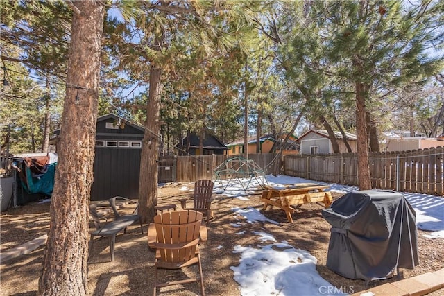 view of patio / terrace with an outbuilding, a fenced backyard, and a grill