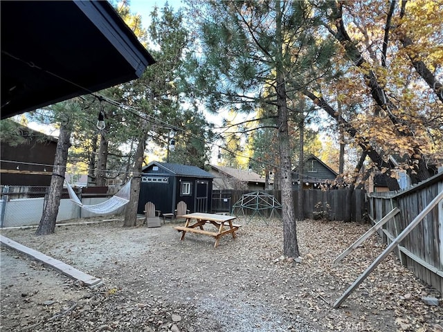 view of yard with a fenced backyard and an outbuilding