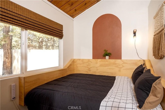 bedroom with lofted ceiling, wood ceiling, and crown molding