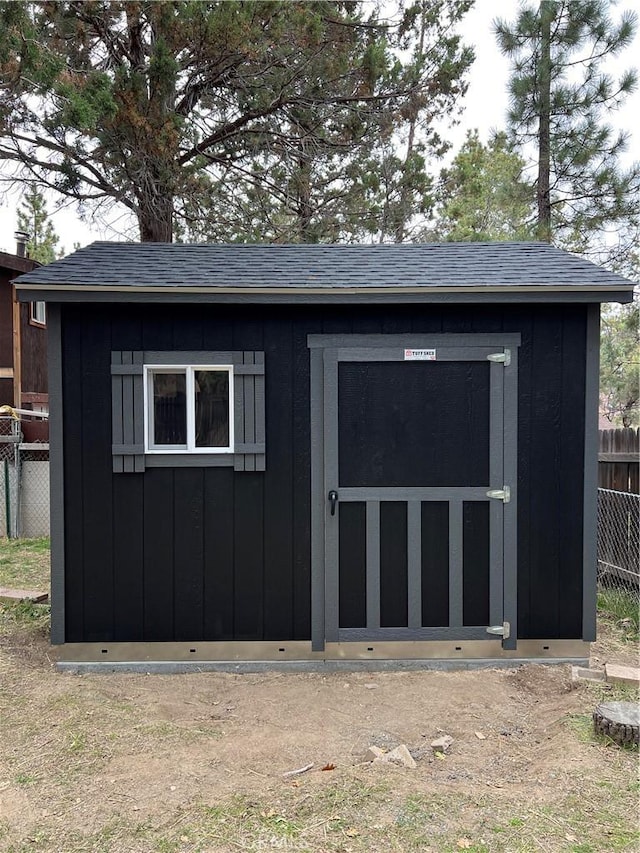 view of shed with fence