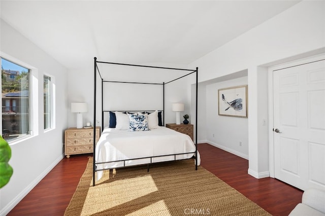 bedroom featuring baseboards and wood finished floors