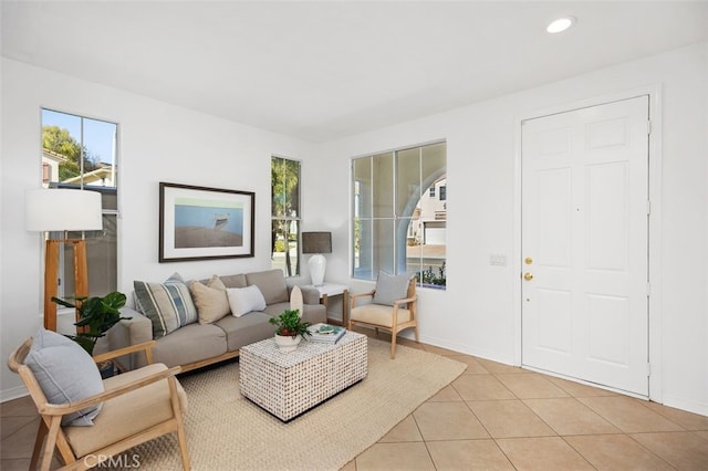 living area featuring light tile patterned floors, recessed lighting, and baseboards