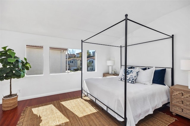 bedroom featuring baseboards and wood finished floors