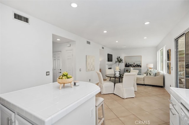 dining space featuring light tile patterned floors, visible vents, and recessed lighting