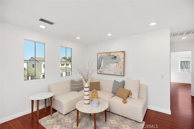 living area featuring recessed lighting, visible vents, baseboards, and wood finished floors