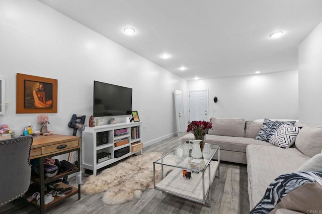 living area featuring baseboards, wood finished floors, and recessed lighting