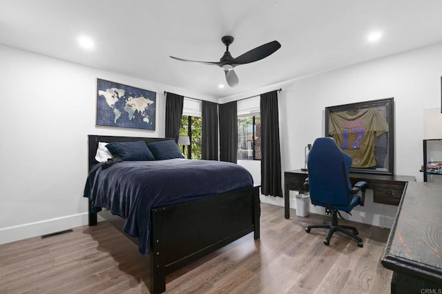 bedroom with ceiling fan, baseboards, wood finished floors, and recessed lighting