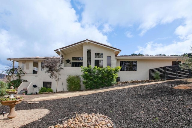 view of front of property with fence and stucco siding