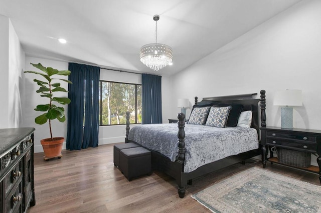 bedroom with recessed lighting, an inviting chandelier, vaulted ceiling, wood finished floors, and baseboards
