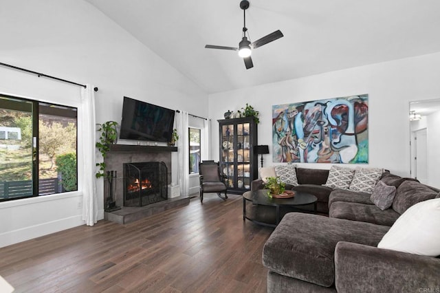 living area featuring high vaulted ceiling, wood finished floors, ceiling fan, a fireplace, and baseboards