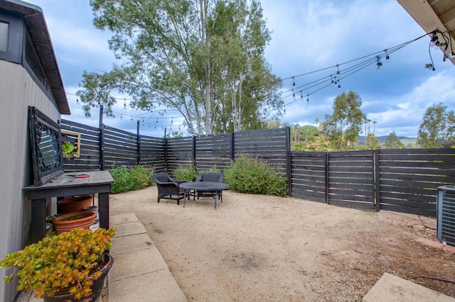 view of patio / terrace featuring a fenced backyard and central AC unit