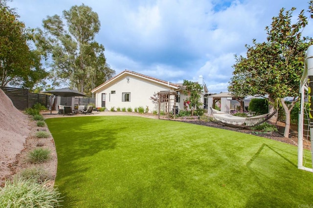 view of yard with a patio and fence
