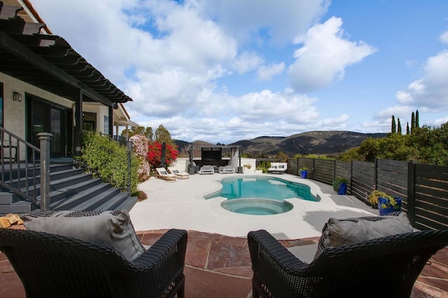 view of swimming pool with a fenced backyard, a mountain view, a patio, a fenced in pool, and an in ground hot tub
