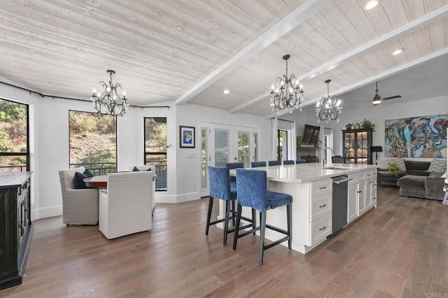 kitchen with a kitchen breakfast bar, a sink, open floor plan, vaulted ceiling with beams, and french doors