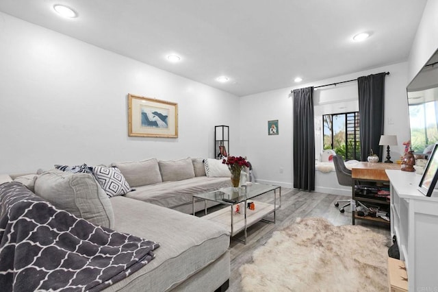 living area featuring baseboards, wood finished floors, and recessed lighting