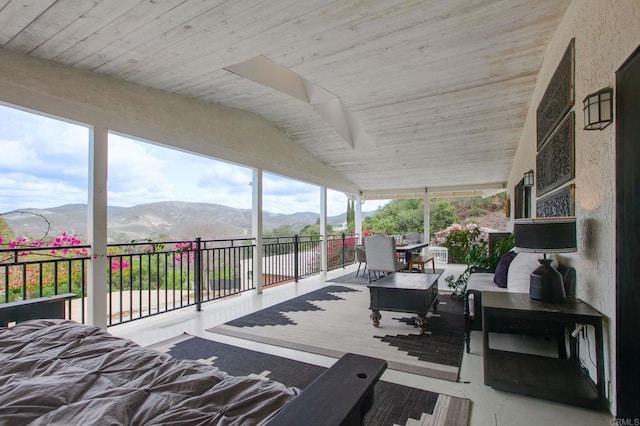 deck with a mountain view, outdoor dining space, and outdoor lounge area
