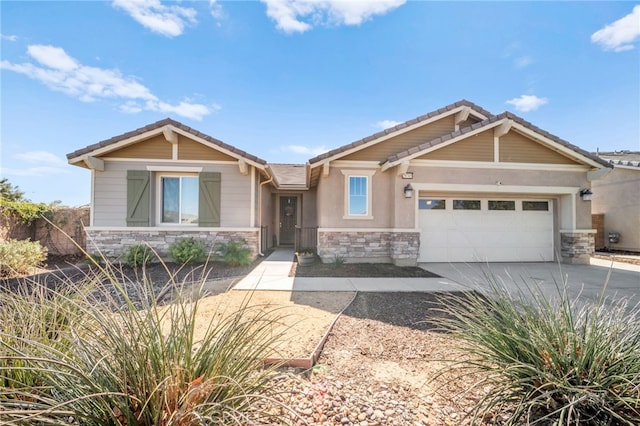 craftsman-style house featuring a garage, stone siding, a tile roof, and concrete driveway