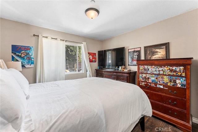 bedroom with dark wood finished floors