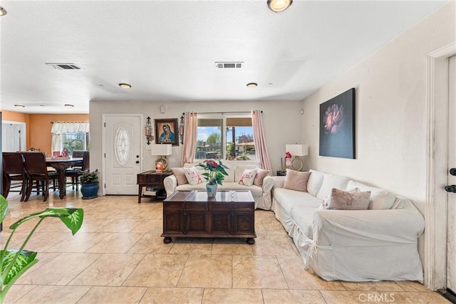 living room featuring visible vents