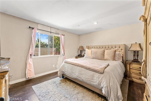 bedroom with baseboards, wood finished floors, and recessed lighting