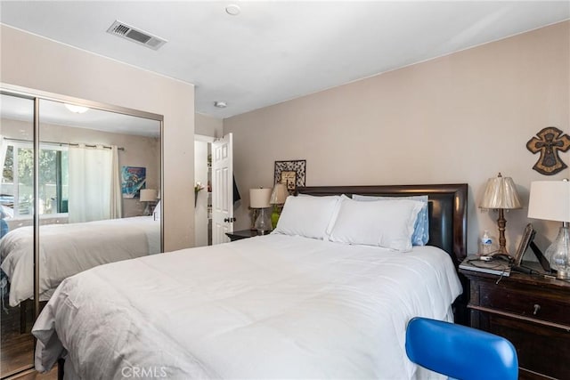 bedroom with visible vents and a closet