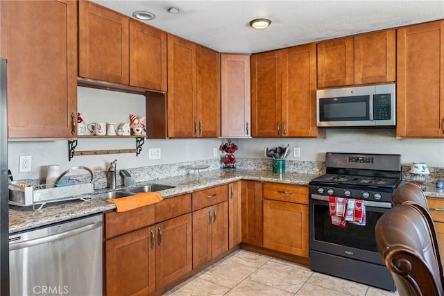 kitchen with open shelves, light stone countertops, light tile patterned floors, and stainless steel appliances