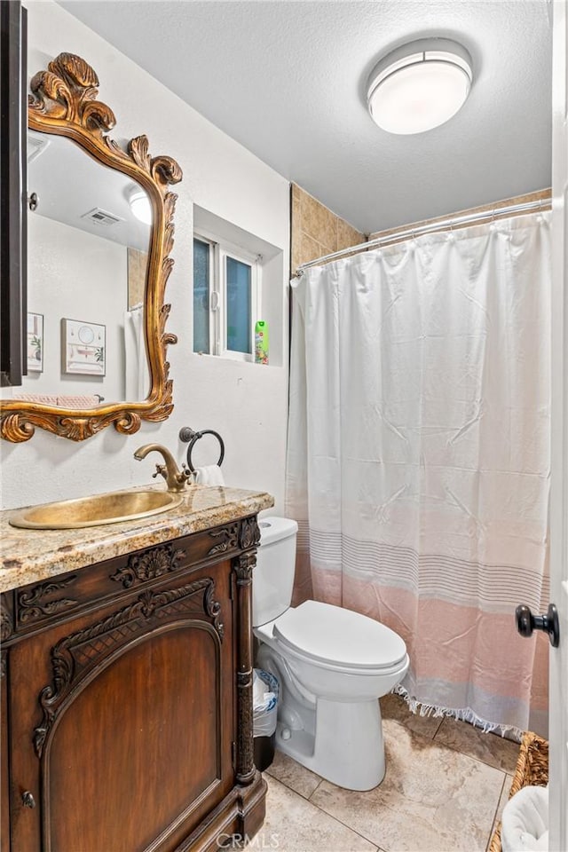 full bathroom with visible vents, toilet, tile patterned flooring, a textured ceiling, and vanity