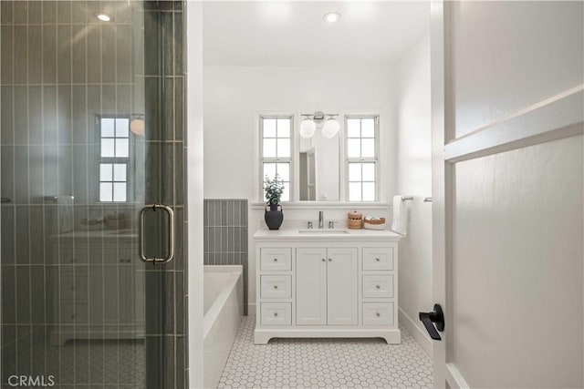 bathroom featuring a garden tub, tile walls, a stall shower, vanity, and tile patterned flooring