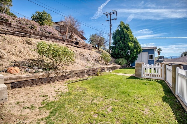 view of yard featuring fence and an outdoor structure