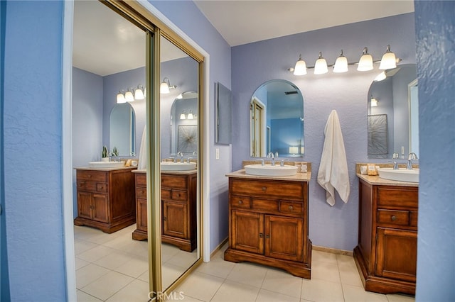 full bathroom with two vanities and a sink