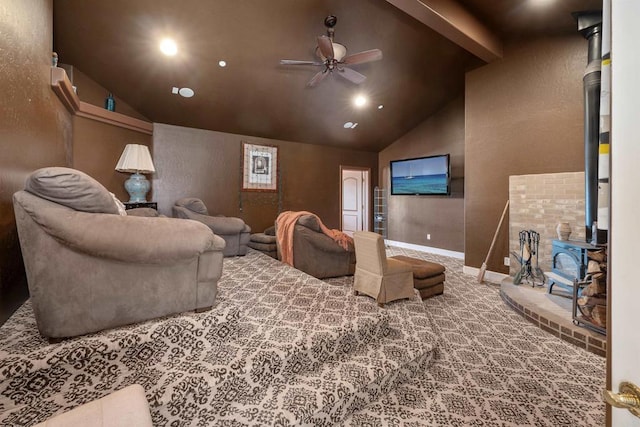 home theater room with carpet floors, a wood stove, vaulted ceiling, and a ceiling fan