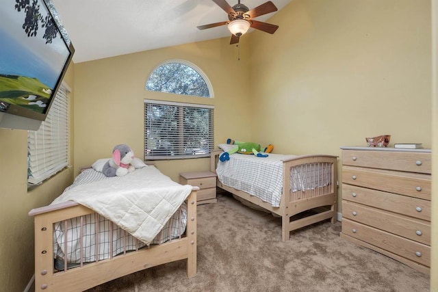 bedroom with carpet floors, vaulted ceiling, and ceiling fan