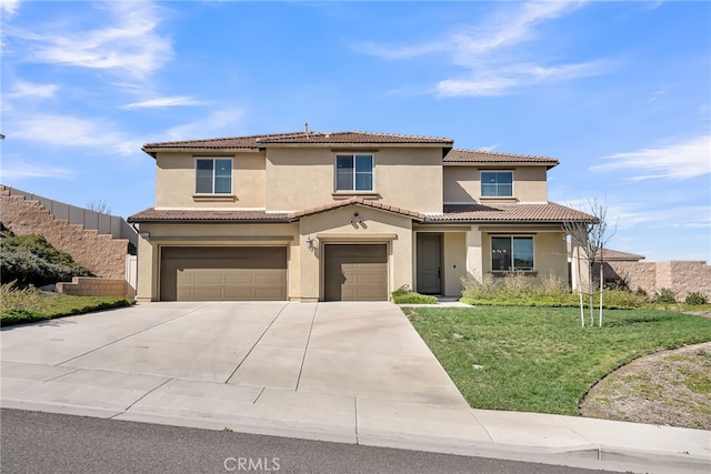 mediterranean / spanish-style house with a tile roof, stucco siding, concrete driveway, an attached garage, and a front lawn