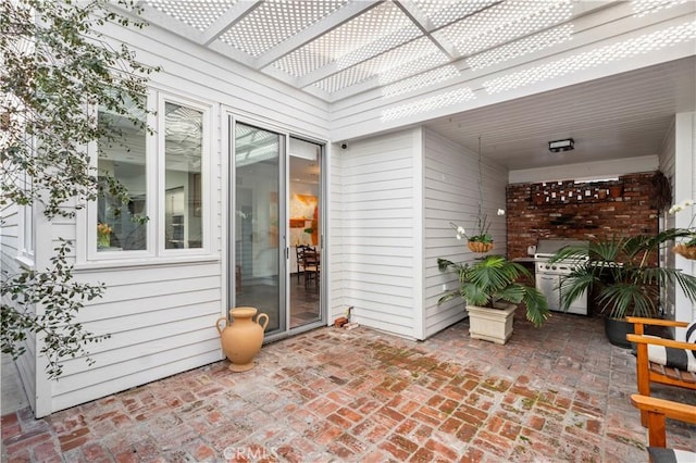 view of patio / terrace with area for grilling and a pergola