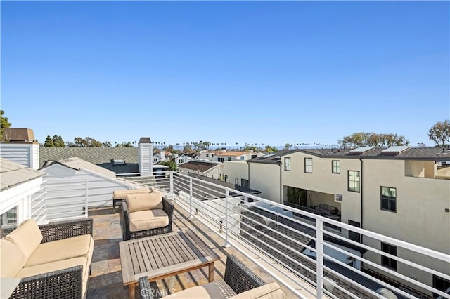 balcony featuring an outdoor living space and a residential view