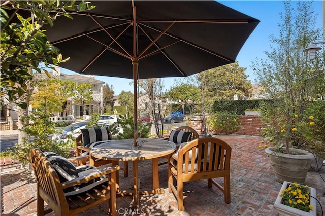 view of patio featuring outdoor dining space and fence