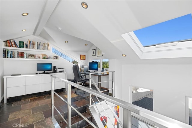 home office featuring lofted ceiling with skylight, stone tile flooring, and recessed lighting