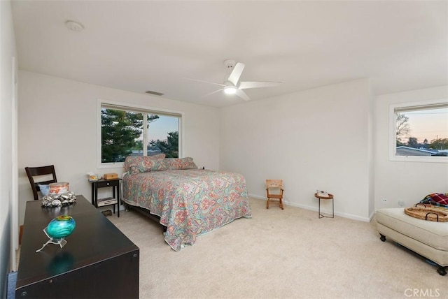 bedroom with baseboards, visible vents, ceiling fan, and carpet flooring